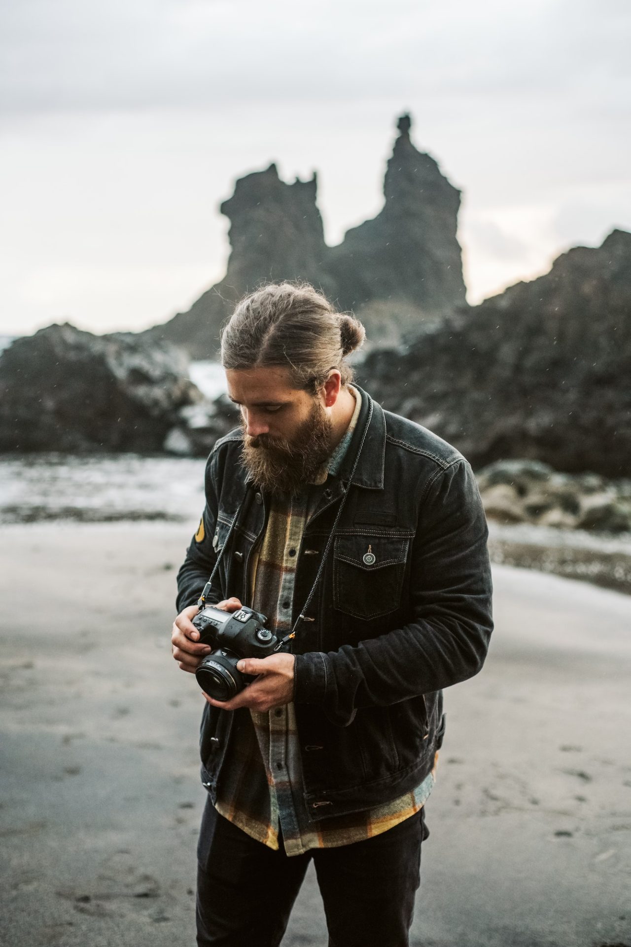 bearded photographer standing near sea