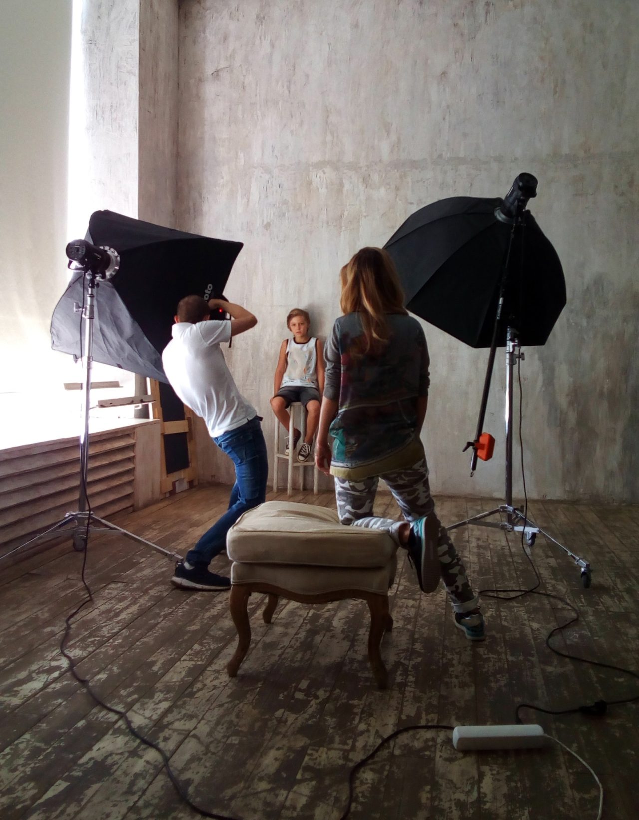 photographers shoot a boy in a modern studio